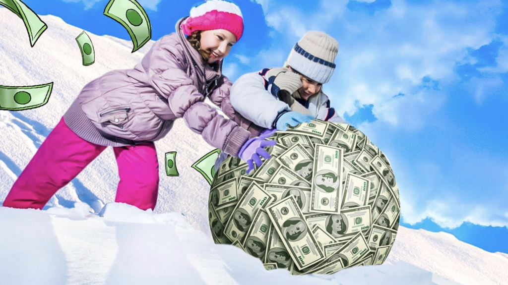 The Dividend Snowball Effect Thumbnail with 2 people in the snowy hill pushing a ball of money